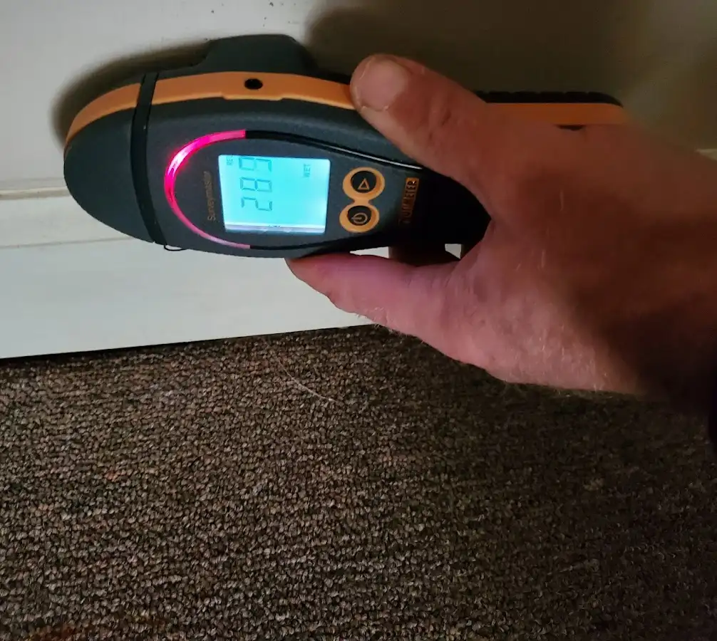 Moisture detection at baseboard during Storm Damage Restoration in Kissimmee